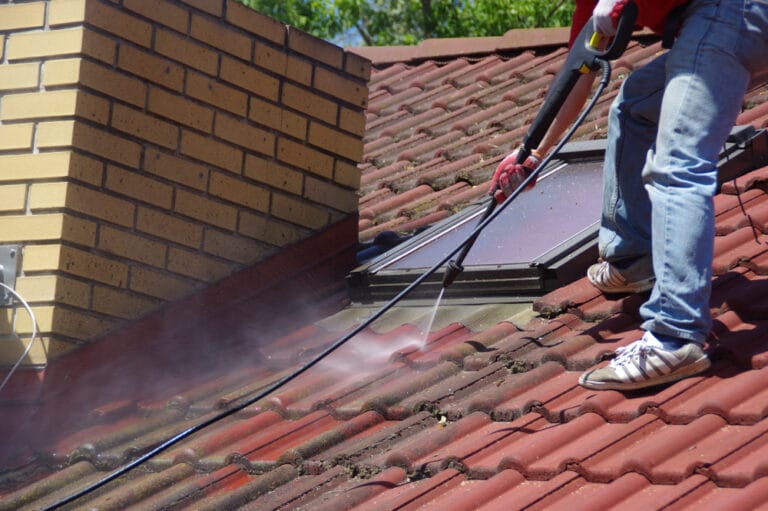 Professional roof services including cleaning, repairs, and painting on a residential property